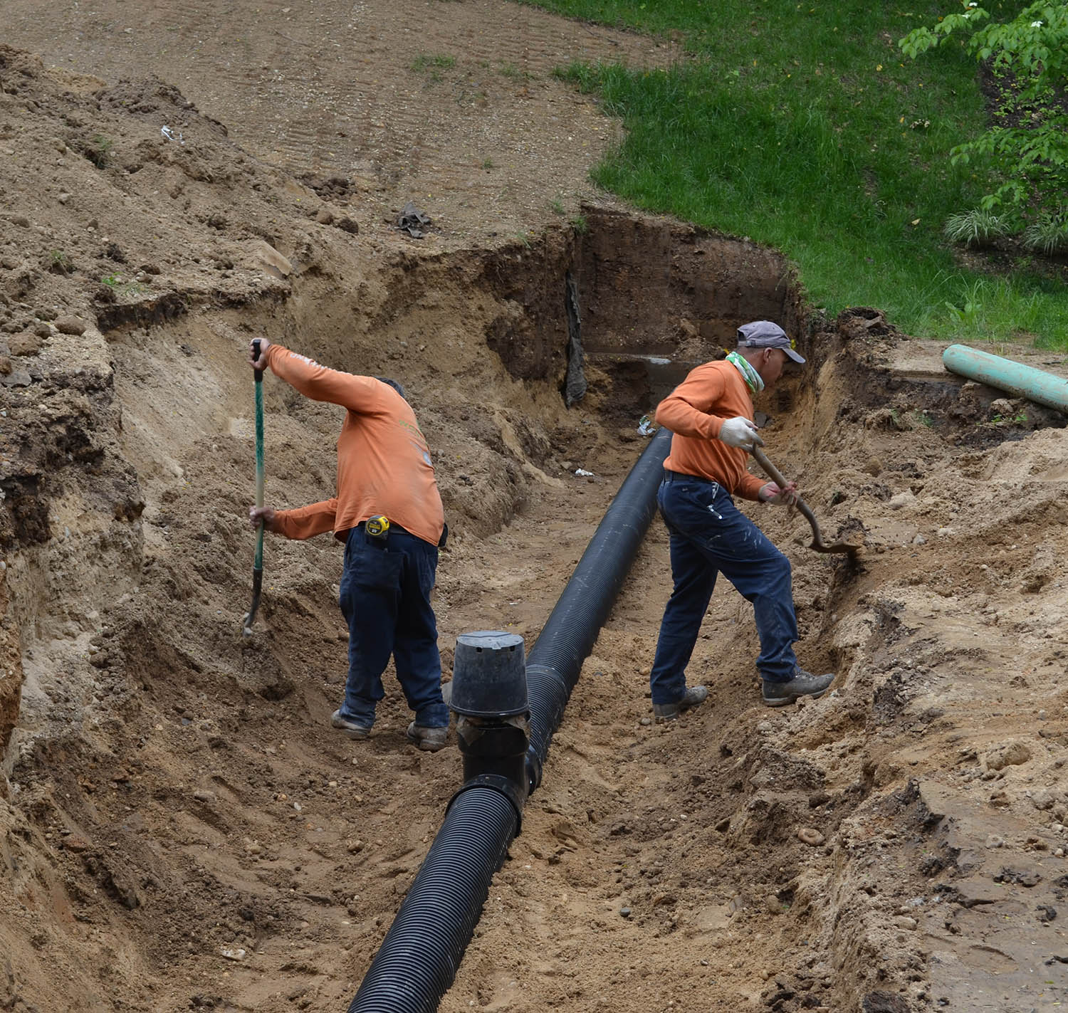 workers setting up a draining system
